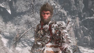 A monkey warrior stands against a backdrop of a snowy mountain scene in Black Myth: Wukong