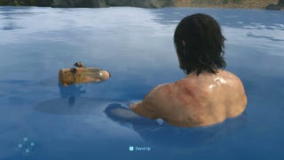 A masculine character bobs in blue water with a floating jar nearby. We see the character from the back and they are topless. The jar has a baby in. It's Death Stranding.