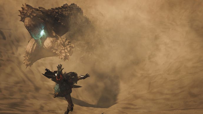 Monster Hunter Wilds official image showing a hunter diving away from a sandworm in close up