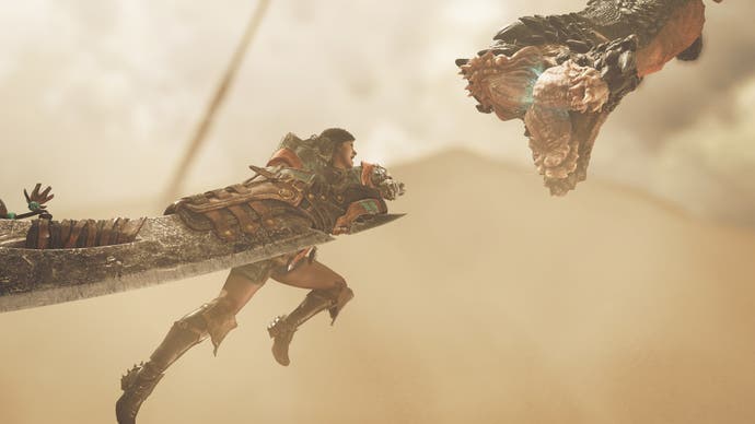 Monster Hunter Wilds official image showing hunter attacking desert worm