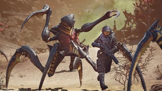 A Starship Troopers: Extermination screenshot showing a heavily armed soldier running away from a marauding bug in the desert.